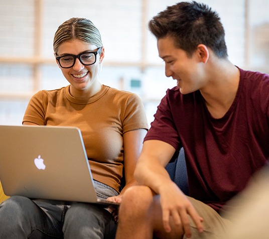 friends studying on a laptop
